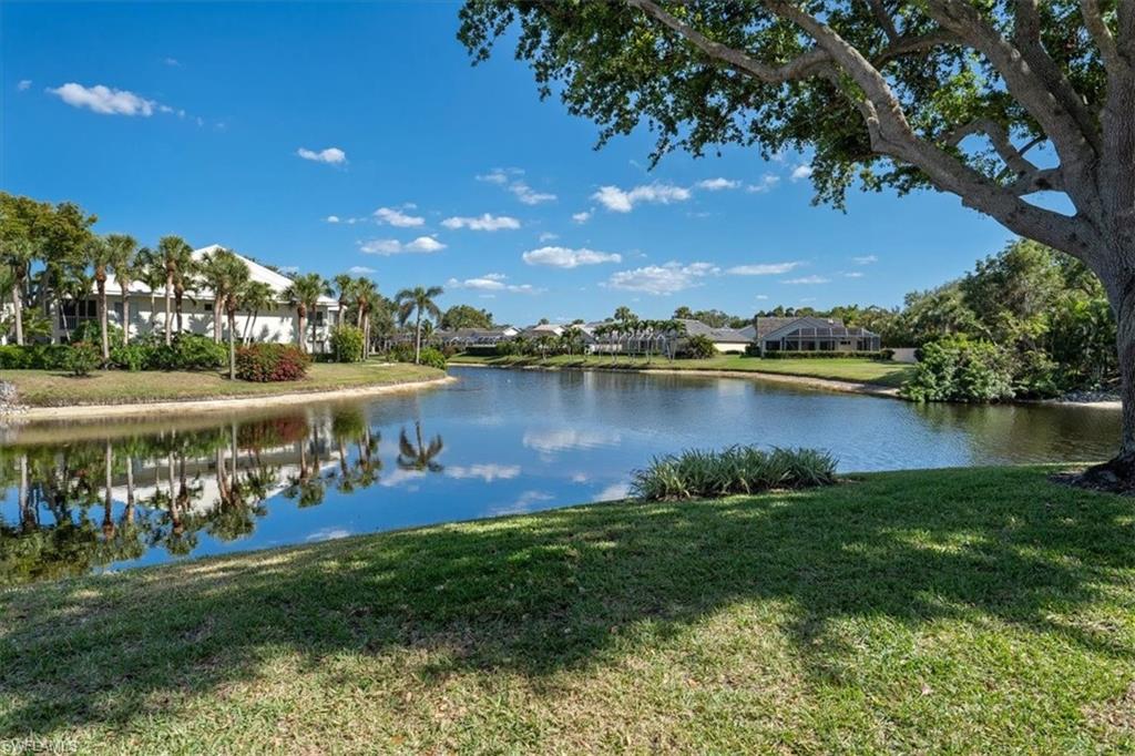 760 Willowbrook Drive, Unit 1204 Naples, FL 34108 - Photo 25 of 25 a view of a lake with houses in the back