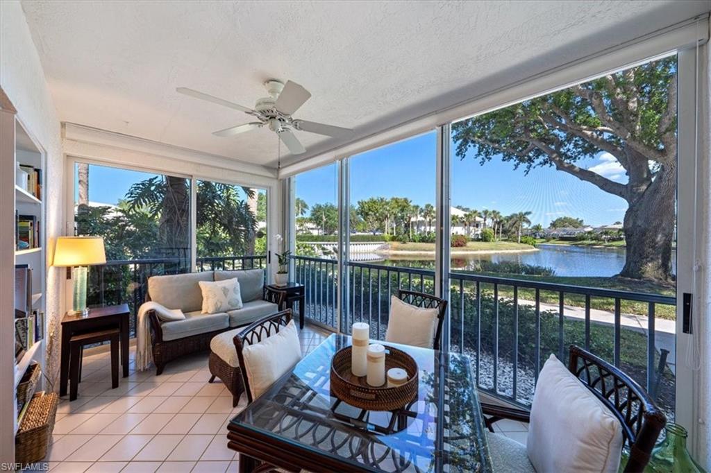 760 Willowbrook Drive, Unit 1204 Naples, FL 34108 - Photo 6 of 25 a living room with furniture and a floor to ceiling window