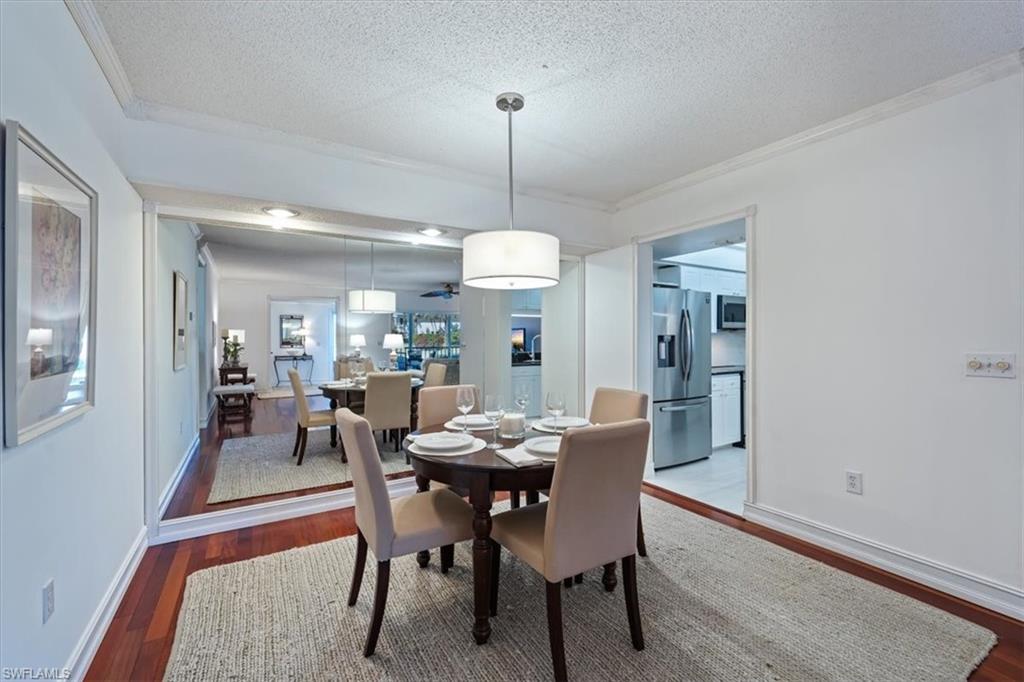 760 Willowbrook Drive, Unit 1204 Naples, FL 34108 - Photo 9 of 25 a dining room with furniture window and wooden floor