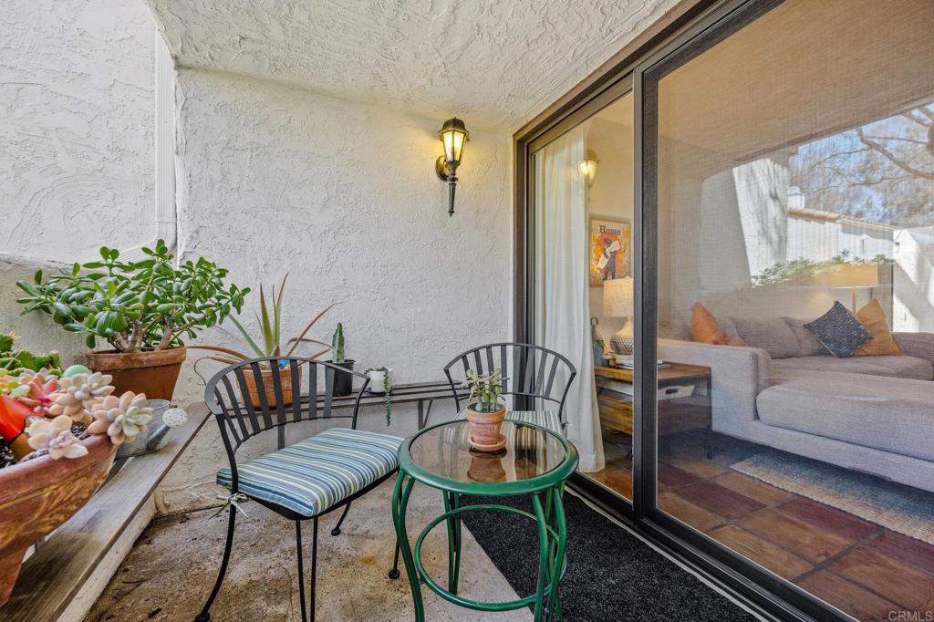 1935 Sunset Drive, Unit 96 Escondido, CA 92025 - Photo 15 of 24 a balcony with furniture and a potted plant
