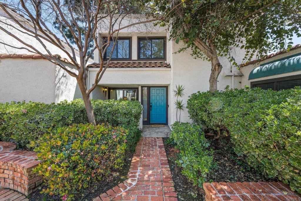 1935 Sunset Drive, Unit 96 Escondido, CA 92025 - Photo 22 of 24 a front view of a house with garden