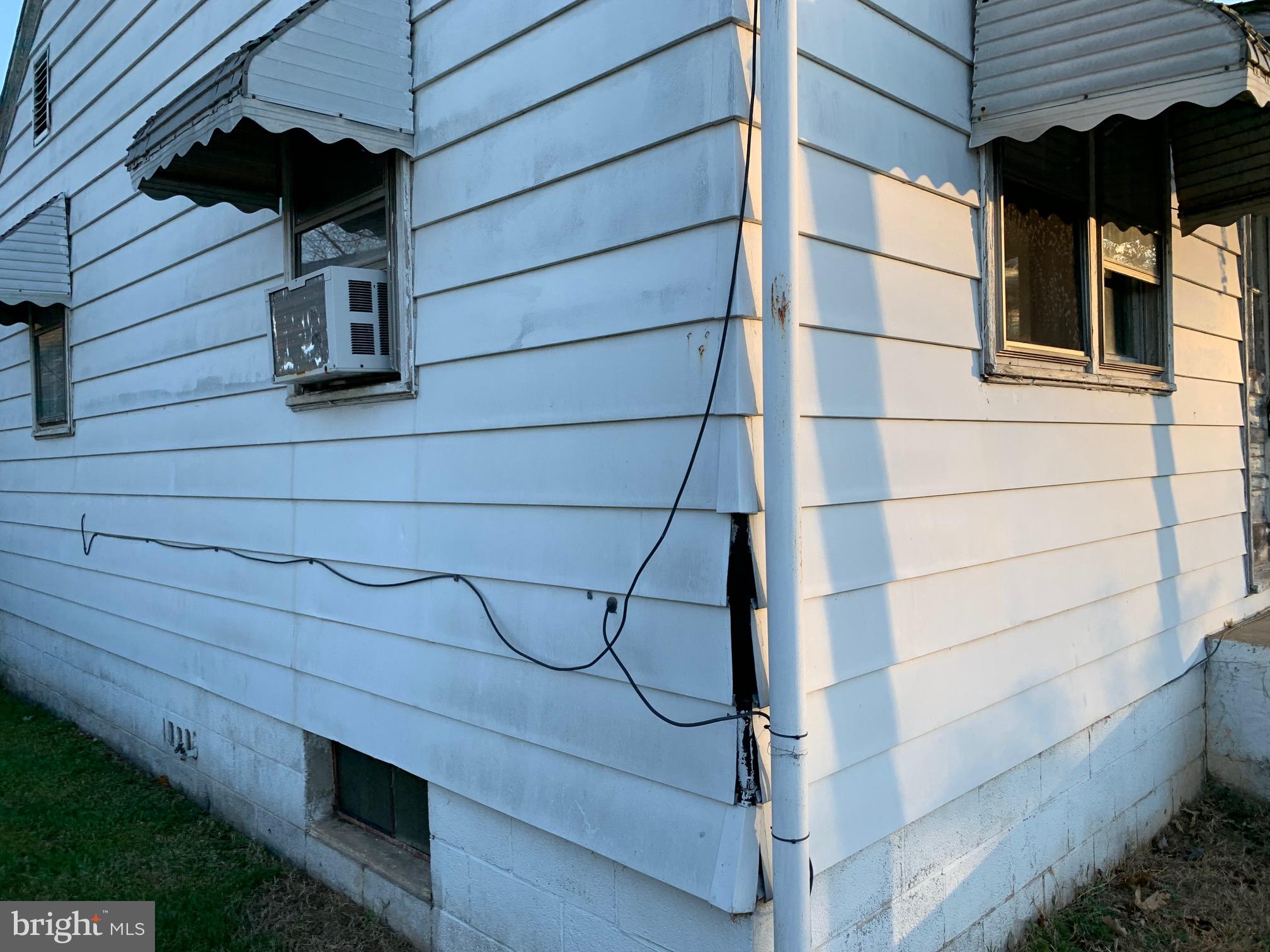 8999 Wellington Road Manassas, VA 20109 - Photo 18 of 20 Front left siding damage