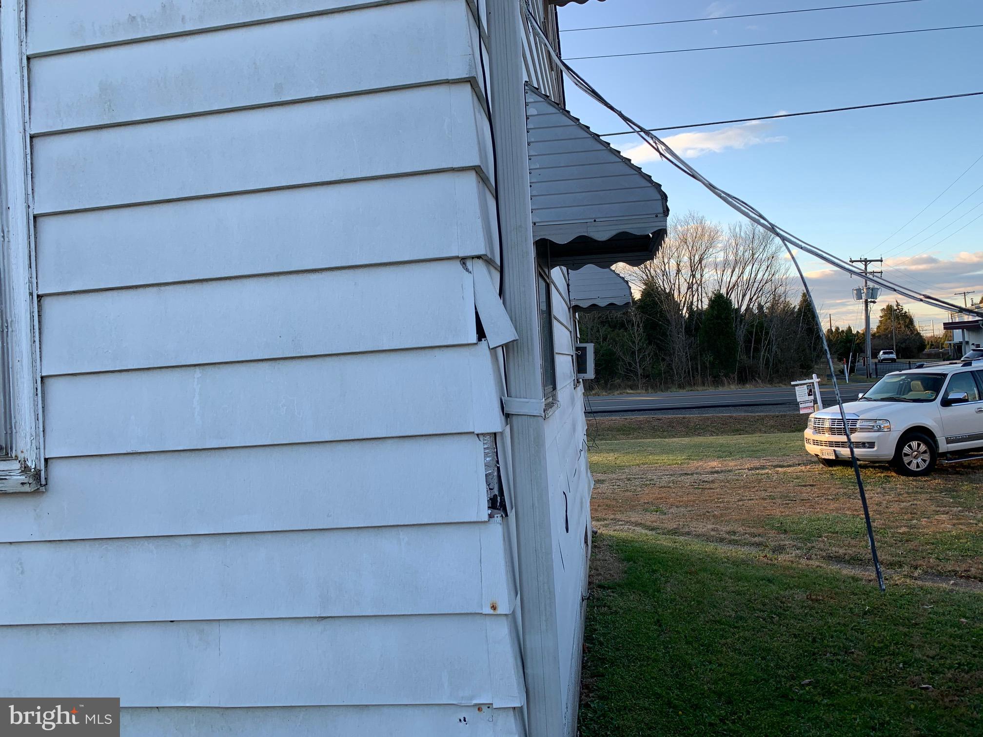 8999 Wellington Road Manassas, VA 20109 - Photo 19 of 20 Back left siding damage
