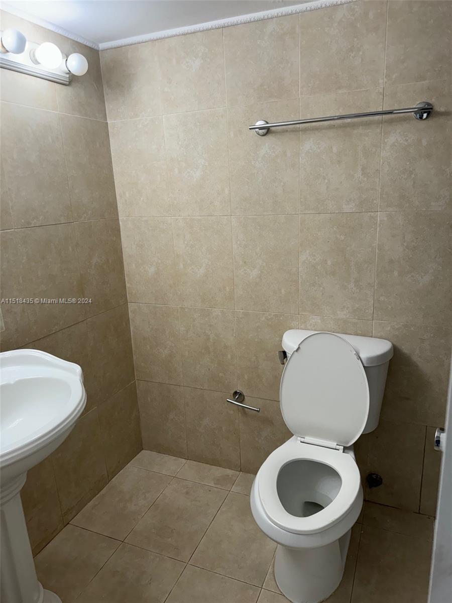8000 Harding Avenue, Unit 4D Miami Beach, FL 33141 - Photo 5 of 16 a bathroom with a toilet and a sink