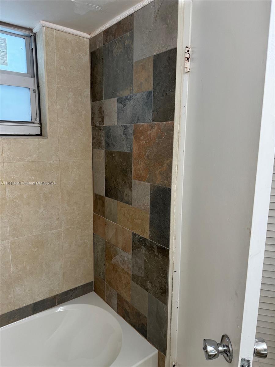 8000 Harding Avenue, Unit 4D Miami Beach, FL 33141 - Photo 9 of 16 a bathroom with a shower