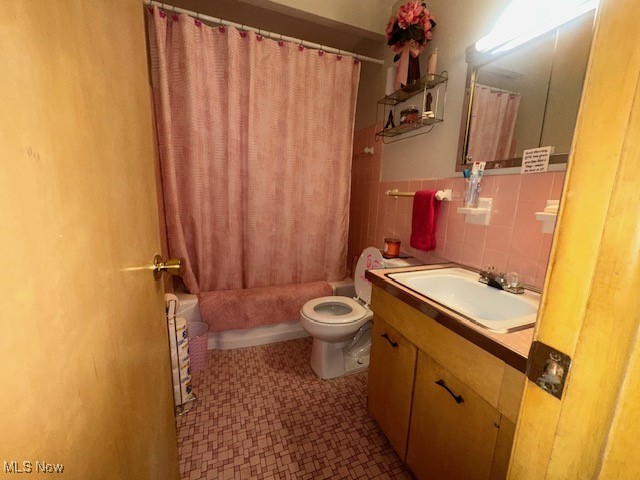 9717 Alexander Road Cleveland, OH 44125 - Photo 5 of 13 Full bath featuring tile walls, vanity, and shower / tub combo