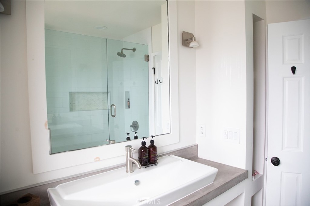201 21st Place, Unit 2 Manhattan Beach, CA 90266 - Photo 20 of 25 a bathroom with a sink and a mirror