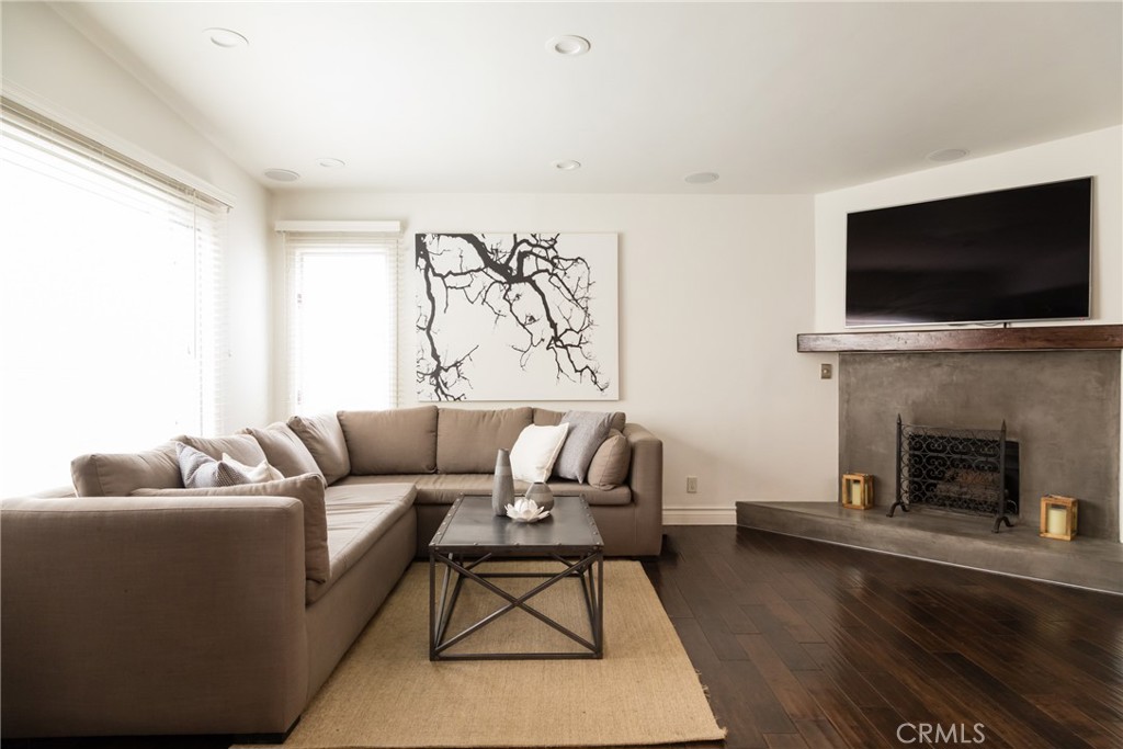 201 21st Place, Unit 2 Manhattan Beach, CA 90266 - Photo 3 of 25 a living room with furniture a flat screen tv and a fireplace
