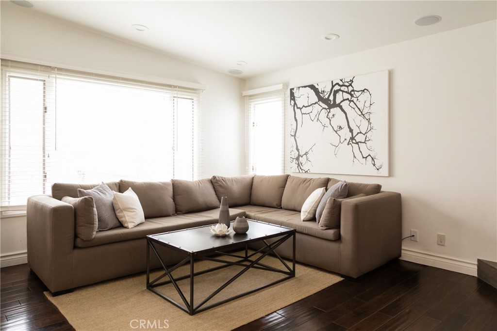201 21st Place, Unit 2 Manhattan Beach, CA 90266 - Photo 4 of 25 a living room with furniture a wooden floor and a large window