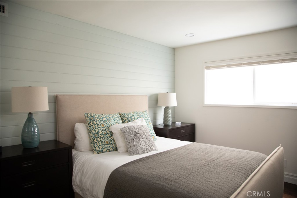 201 21st Place, Unit 2 Manhattan Beach, CA 90266 - Photo 8 of 25 a bedroom with a bed and wooden floor