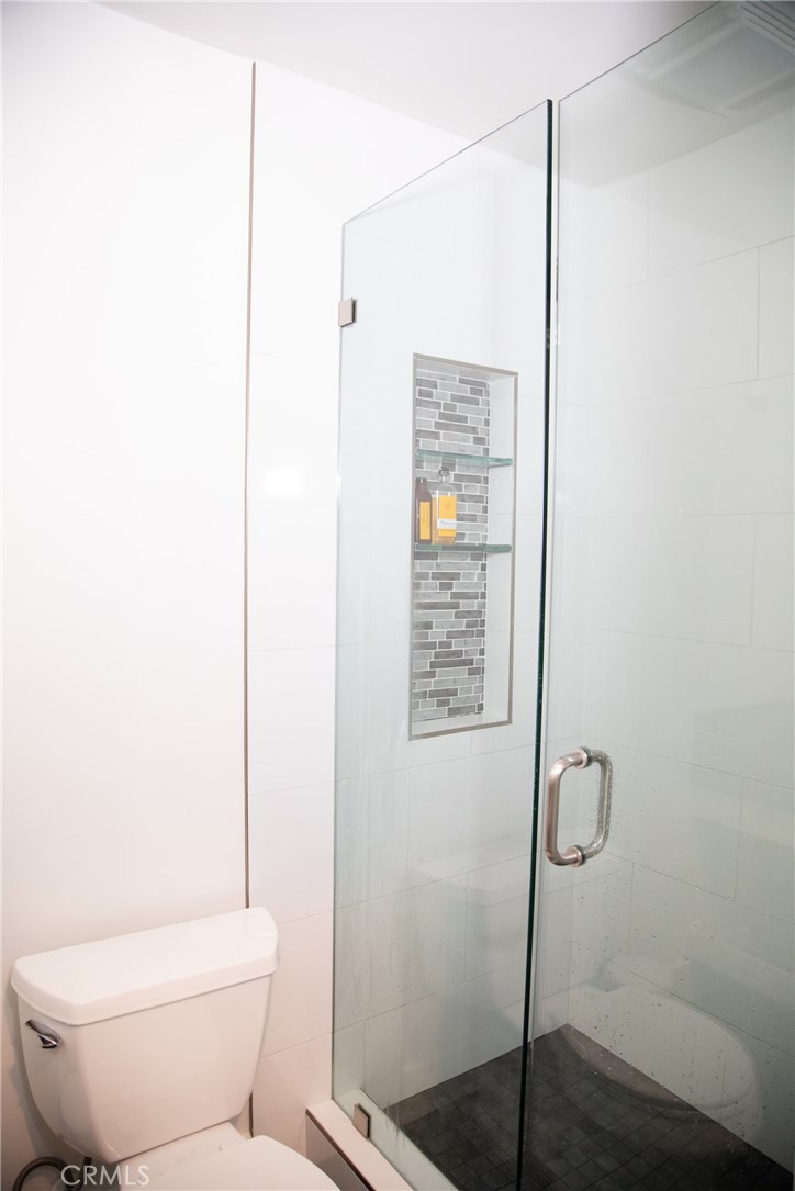 201 21st Place, Unit 2 Manhattan Beach, CA 90266 - Photo 9 of 25 a white toilet sitting next to a shower