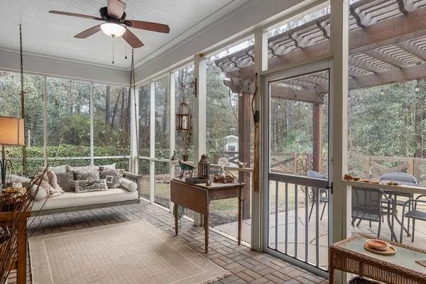 a living room with furniture and a floor to ceiling window