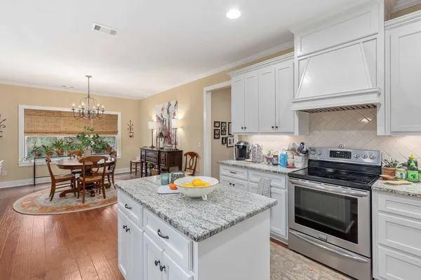 a view of a dining room with furniture and chandelier
