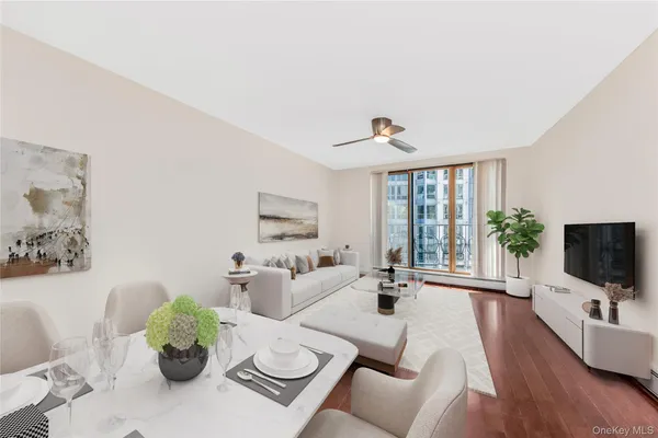a living room with furniture a flat screen tv and a large window