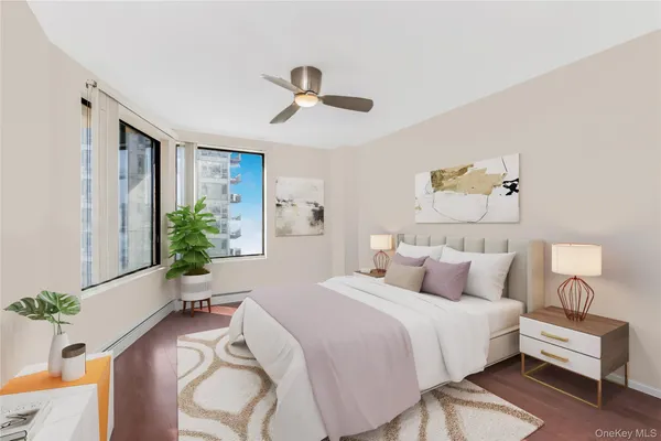 a bedroom with bed tv and window