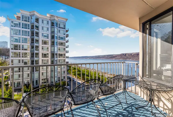 a kitchen with stainless steel appliances granite countertop a refrigerator a stove and a wooden floor