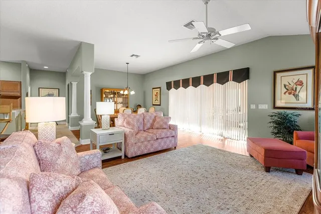 a view of a dining room with furniture wooden floor and chandelier