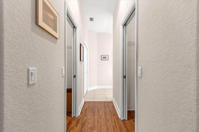 a spacious bathroom with a granite countertop sink a mirror and a shower