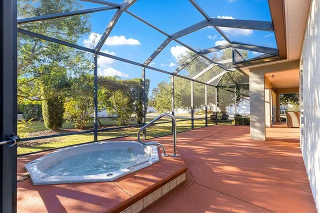a front view of a house with a garden and trees