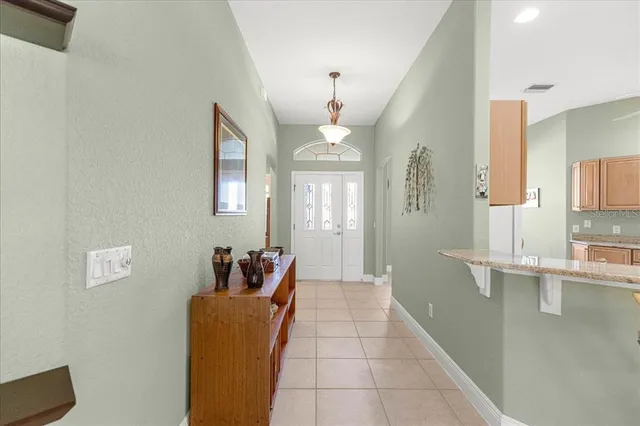 a kitchen with stainless steel appliances granite countertop a sink and a refrigerator