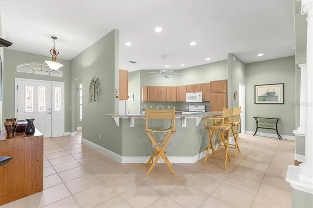 a kitchen with stainless steel appliances granite countertop a sink refrigerator and cabinets