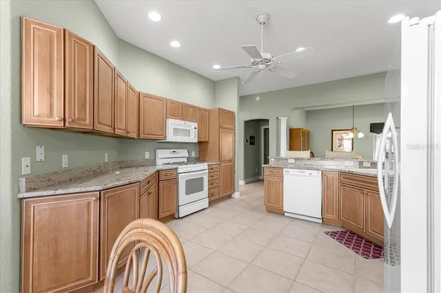 a dining room with furniture a chandelier and window
