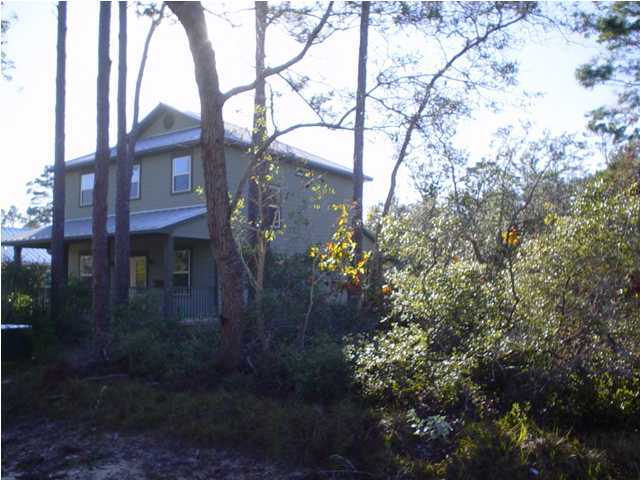 50 Spotted Dolphin Road Santa Rosa Beach, FL 32459 - Photo 3 of 10 a backyard of a house with lots of green space