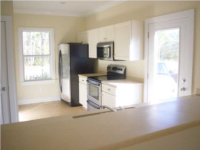50 Spotted Dolphin Road Santa Rosa Beach, FL 32459 - Photo 8 of 10 a kitchen with a refrigerator and a stove top oven