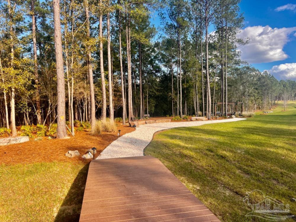 27 Ashbridge Lane Pace, FL 32571 - Photo 16 of 40 a swimming pool with outdoor seating and yard