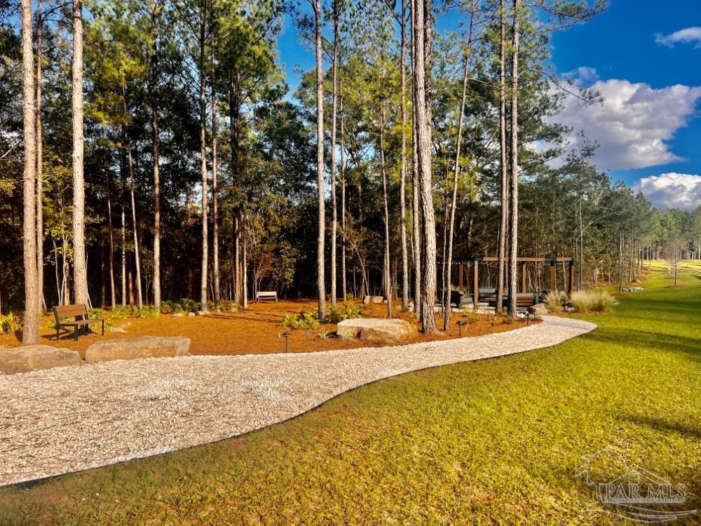 27 Ashbridge Lane Pace, FL 32571 - Photo 18 of 40 a view of a swimming pool with an outdoor space and seating area