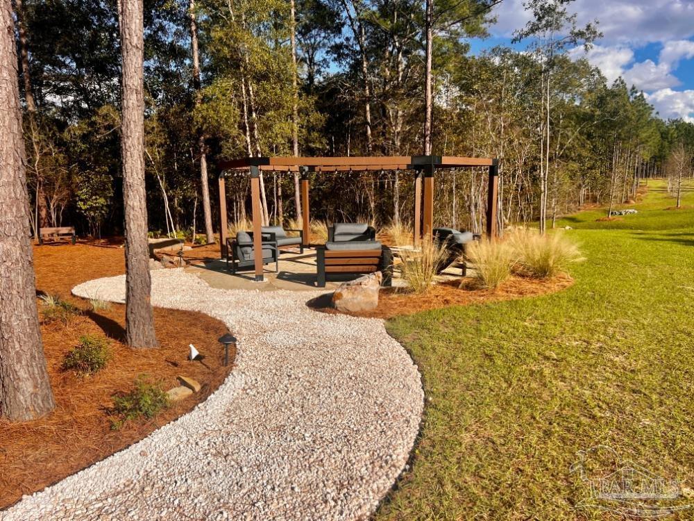 27 Ashbridge Lane Pace, FL 32571 - Photo 20 of 40 a view of a swimming pool with an outdoor seating
