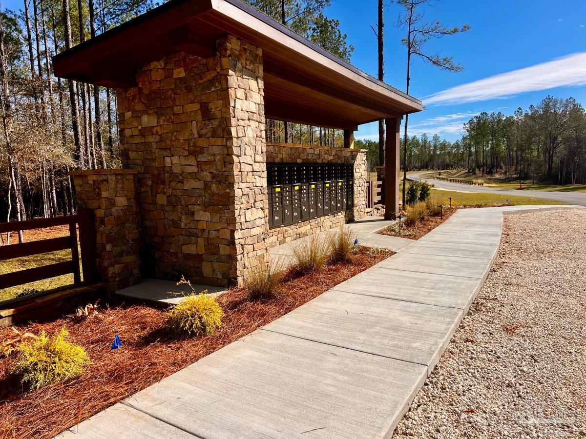 27 Ashbridge Lane Pace, FL 32571 - Photo 21 of 40 a view of a patio with a table and chairs under an umbrella