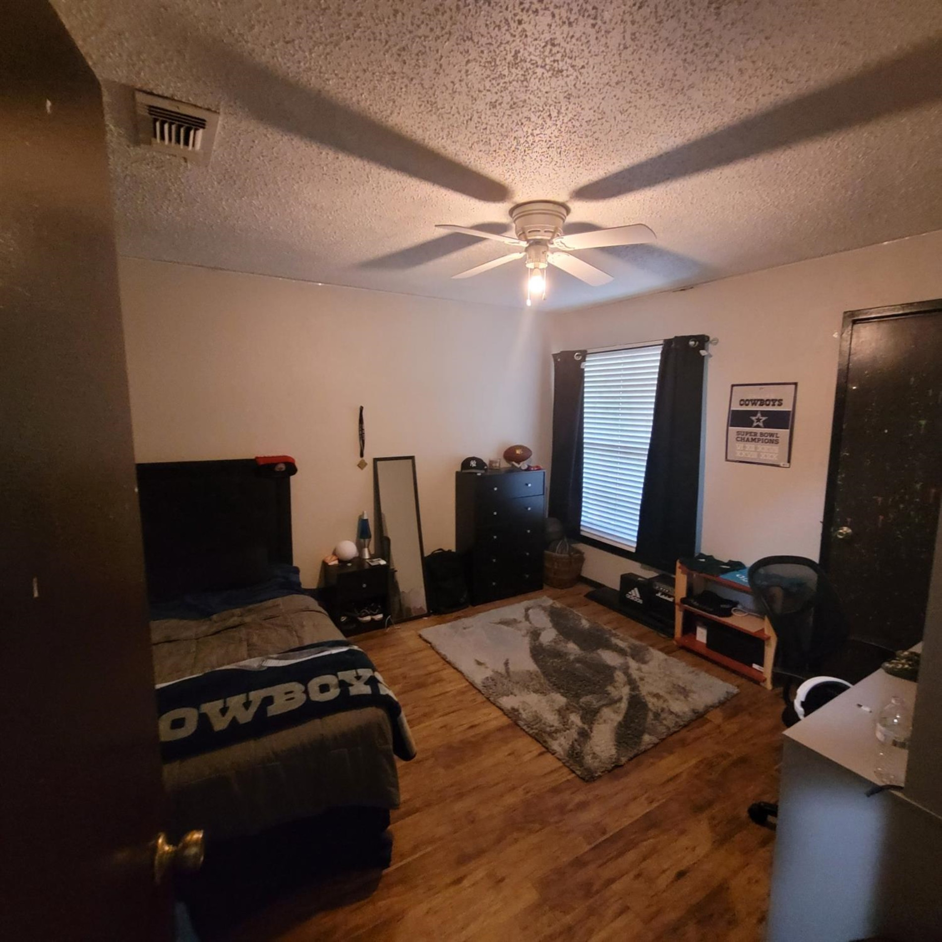 5519 1st Place Lubbock, TX 79416 - Photo 11 of 13 a bedroom with a bed and a flat screen tv