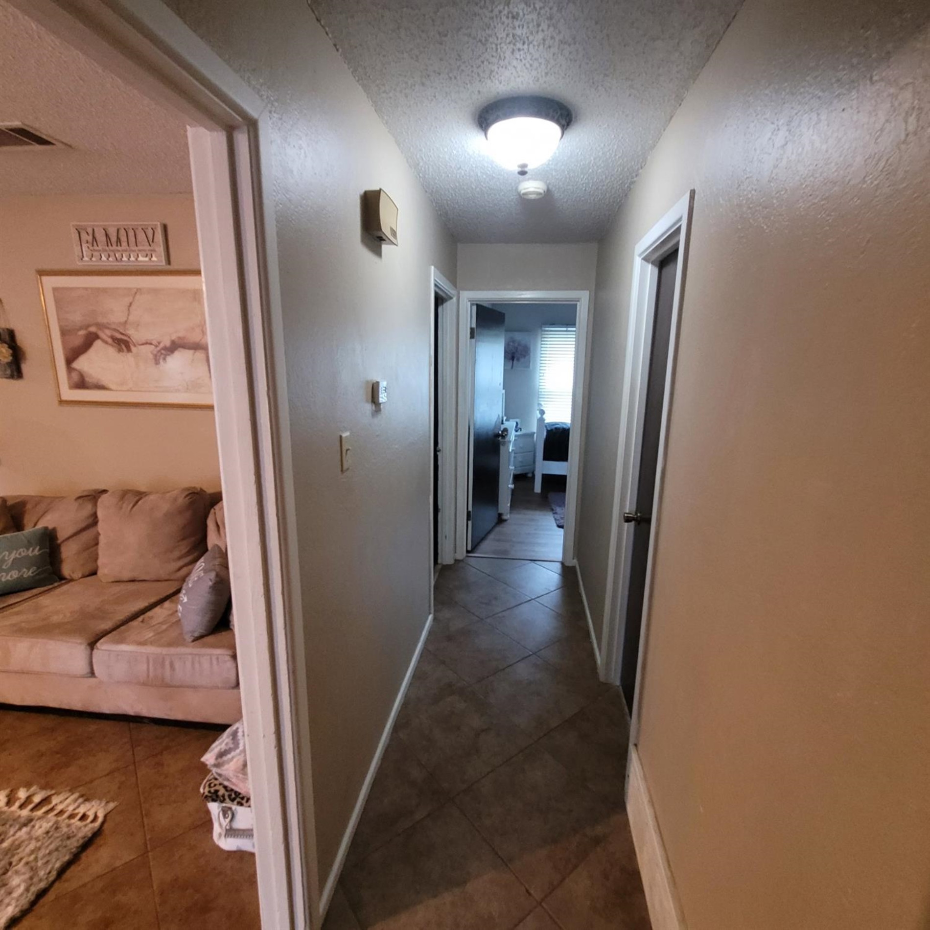 5519 1st Place Lubbock, TX 79416 - Photo 7 of 13 a view of a hallway to a livingroom and a couch