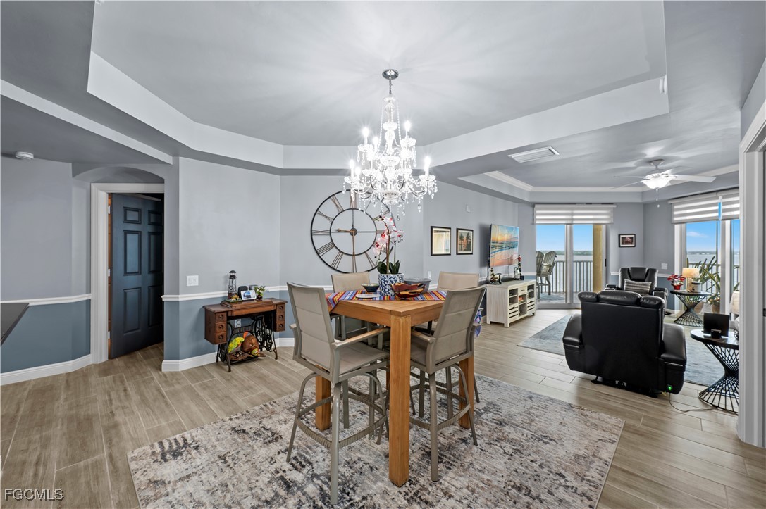 2745 First Street, Unit 1306 Fort Myers, FL 33916 - Photo 12 of 50 a view of a dining room with furniture window and wooden floor