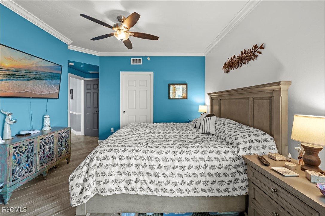 2745 First Street, Unit 1306 Fort Myers, FL 33916 - Photo 24 of 50 a bedroom with a large bed and a chandelier