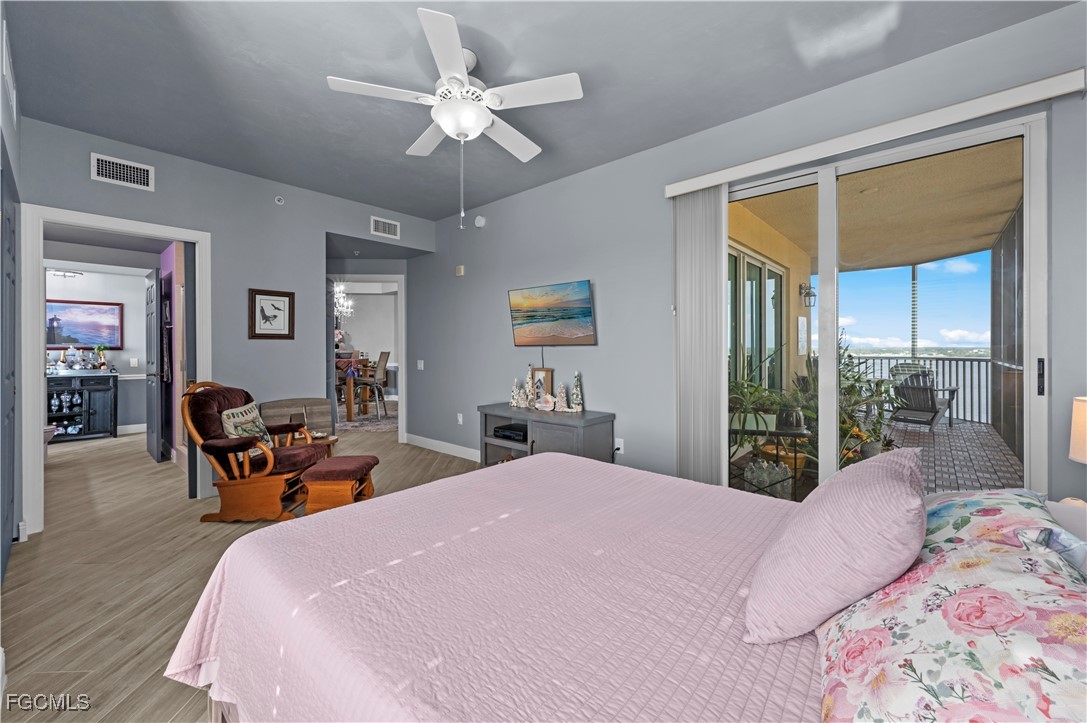 2745 First Street, Unit 1306 Fort Myers, FL 33916 - Photo 31 of 50 a bedroom with a bed and a chandelier