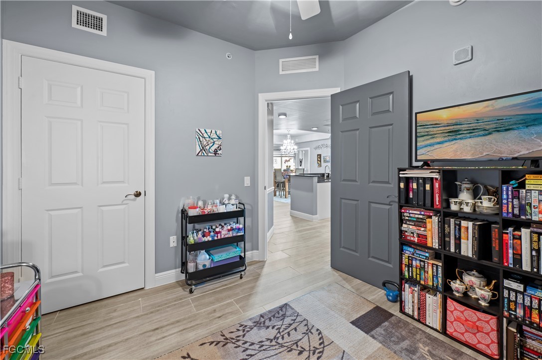 2745 First Street, Unit 1306 Fort Myers, FL 33916 - Photo 35 of 50 a room with furniture and a book shelf
