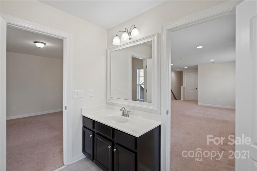 4331 Oxford Mill Road Waxhaw, NC 28173 - Photo 35 of 48 a bathroom with a sink a light fixture and a mirror