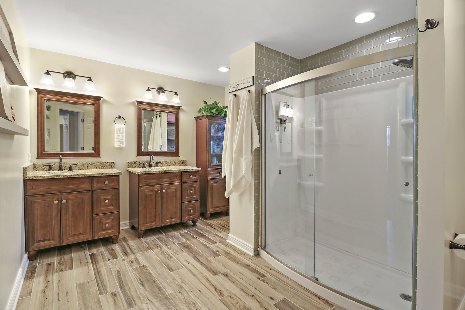 1468 Sutton Circle Wauconda, IL 60084 - Photo 12 of 33 a bathroom with a double vanity sink a mirror and a shower