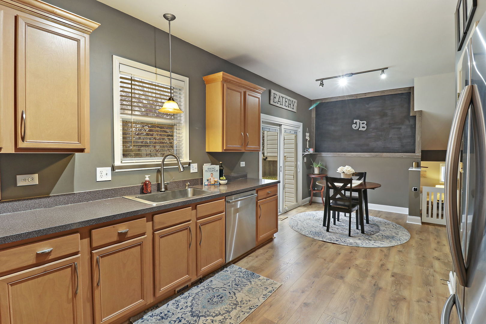 1468 Sutton Circle Wauconda, IL 60084 - Photo 8 of 33 a kitchen with stainless steel appliances granite countertop sink table and chairs