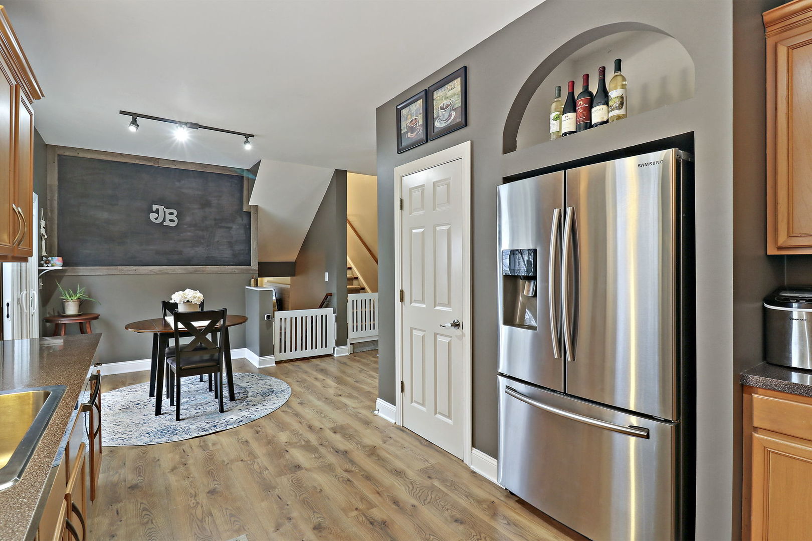 1468 Sutton Circle Wauconda, IL 60084 - Photo 9 of 33 a kitchen with stainless steel appliances granite countertop a refrigerator a stove a microwave oven a dining table and chairs with wooden floor