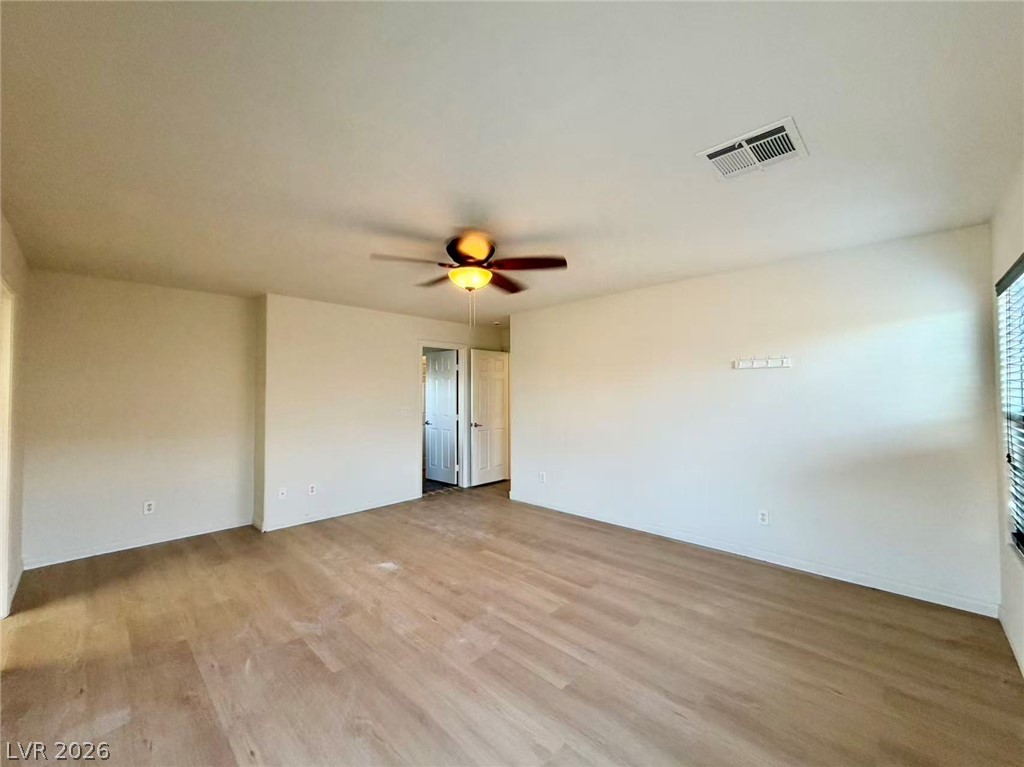 11183 Ranch Valley Street Las Vegas, NV 89179 - Photo 9 of 19 Natural light illuminates the light wood flooring throughout this adaptable living space.