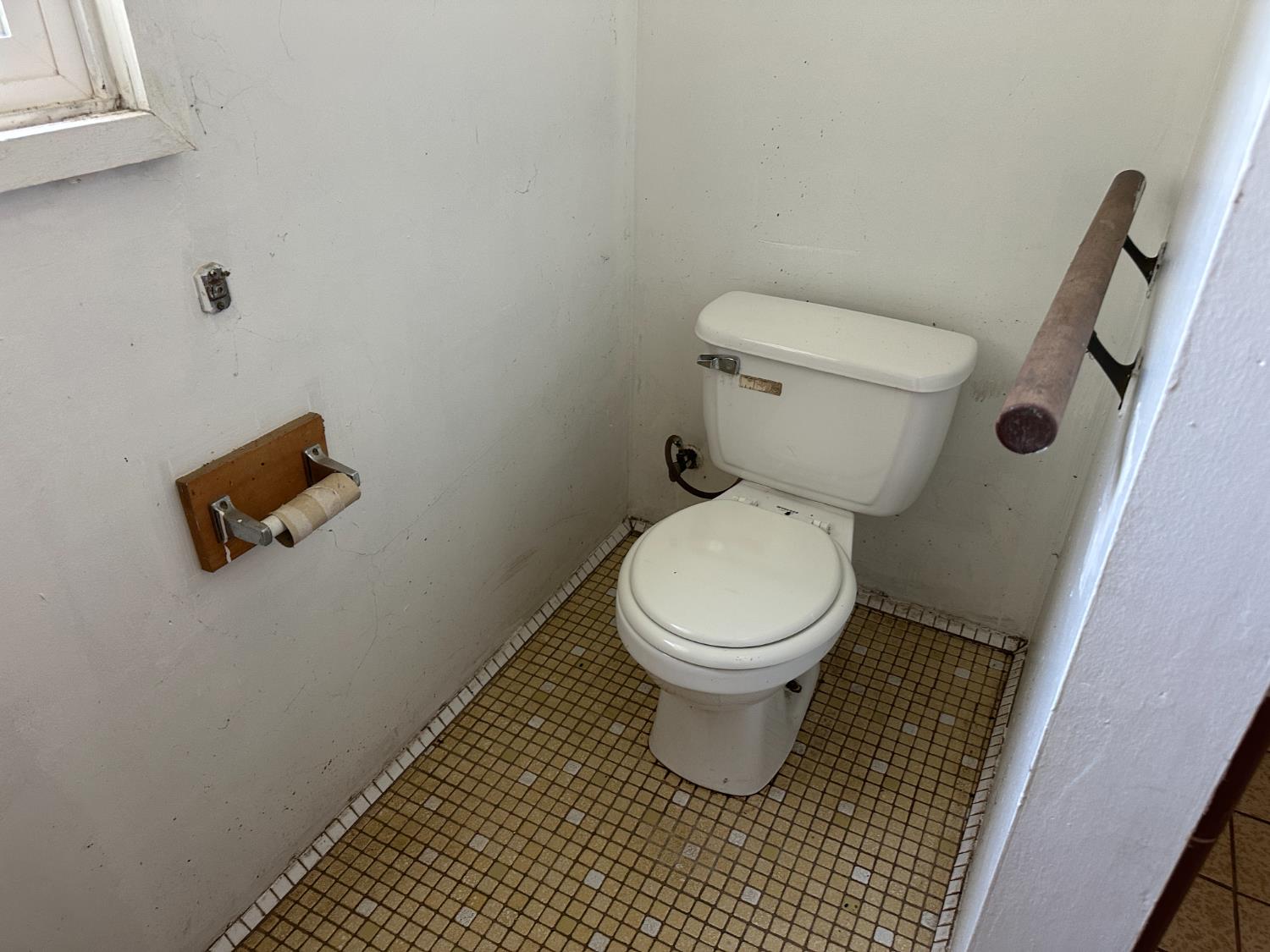 19637 East American Avenue Reedley, CA 93654 - Photo 16 of 40 a white toilet sitting next to a bathroom sink