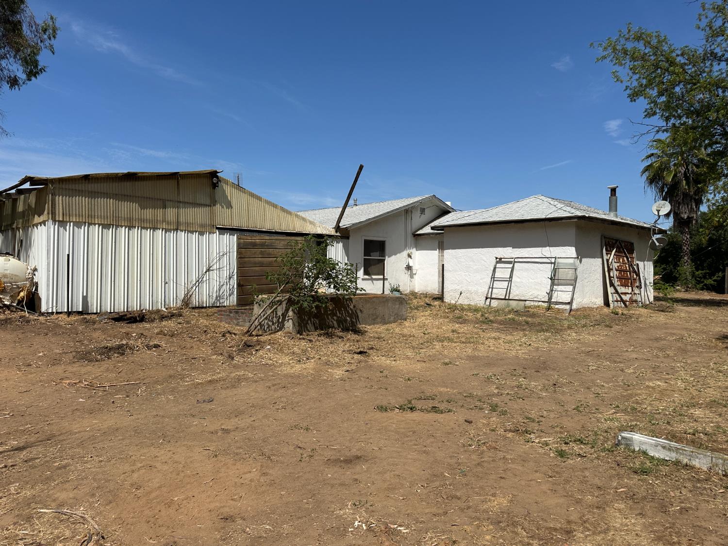 19637 East American Avenue Reedley, CA 93654 - Photo 26 of 40 a view of a house with backyard and sitting area