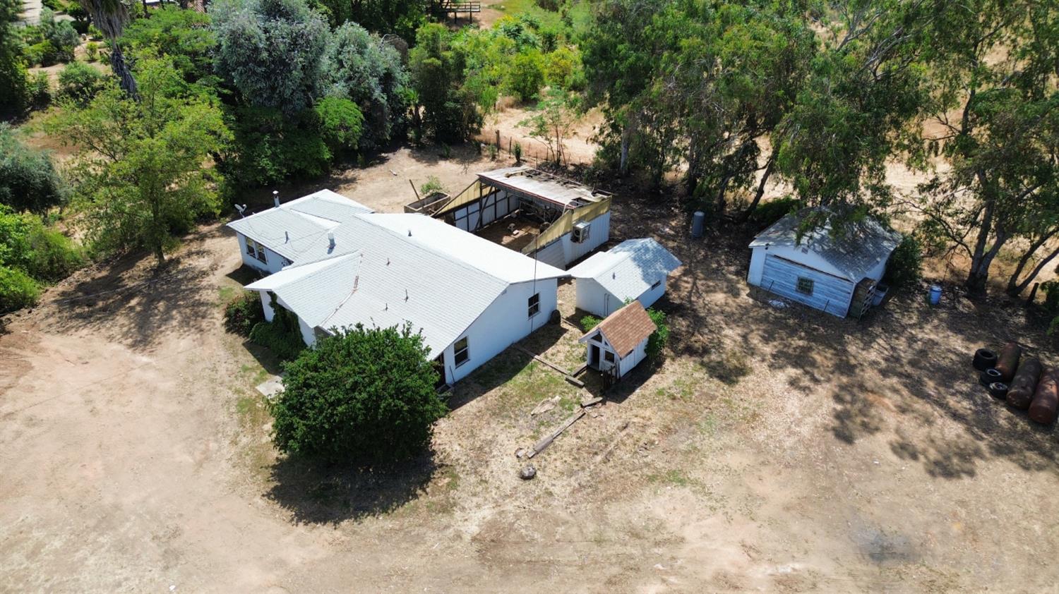 19637 East American Avenue Reedley, CA 93654 - Photo 37 of 40 an aerial view of a house with a yard and covered with trees