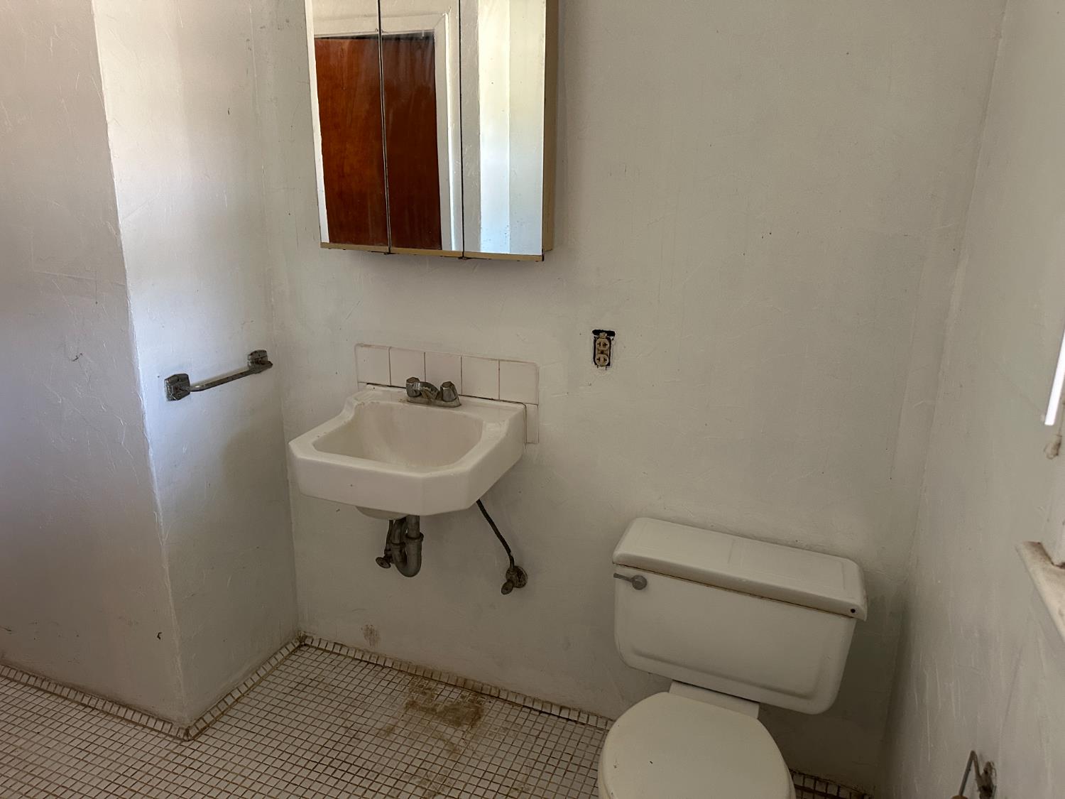 19637 East American Avenue Reedley, CA 93654 - Photo 5 of 40 a bathroom with a toilet sink and mirror