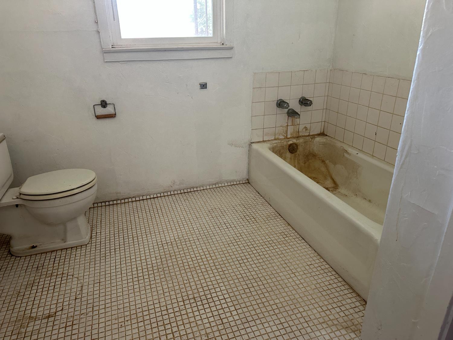 19637 East American Avenue Reedley, CA 93654 - Photo 6 of 40 a bathroom with a sink a toilet and bathtub