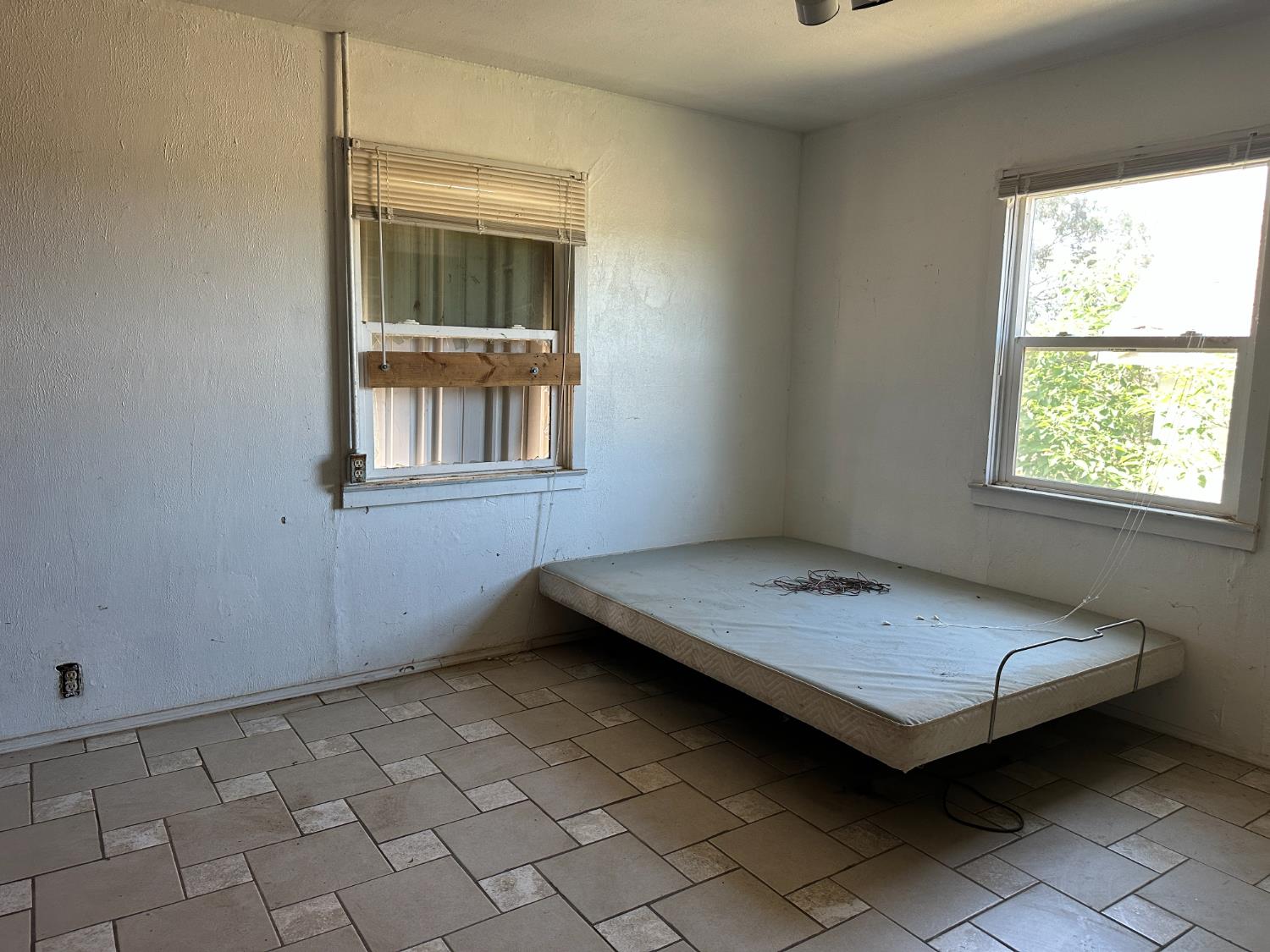 19637 East American Avenue Reedley, CA 93654 - Photo 7 of 40 a bedroom with a bed and a window