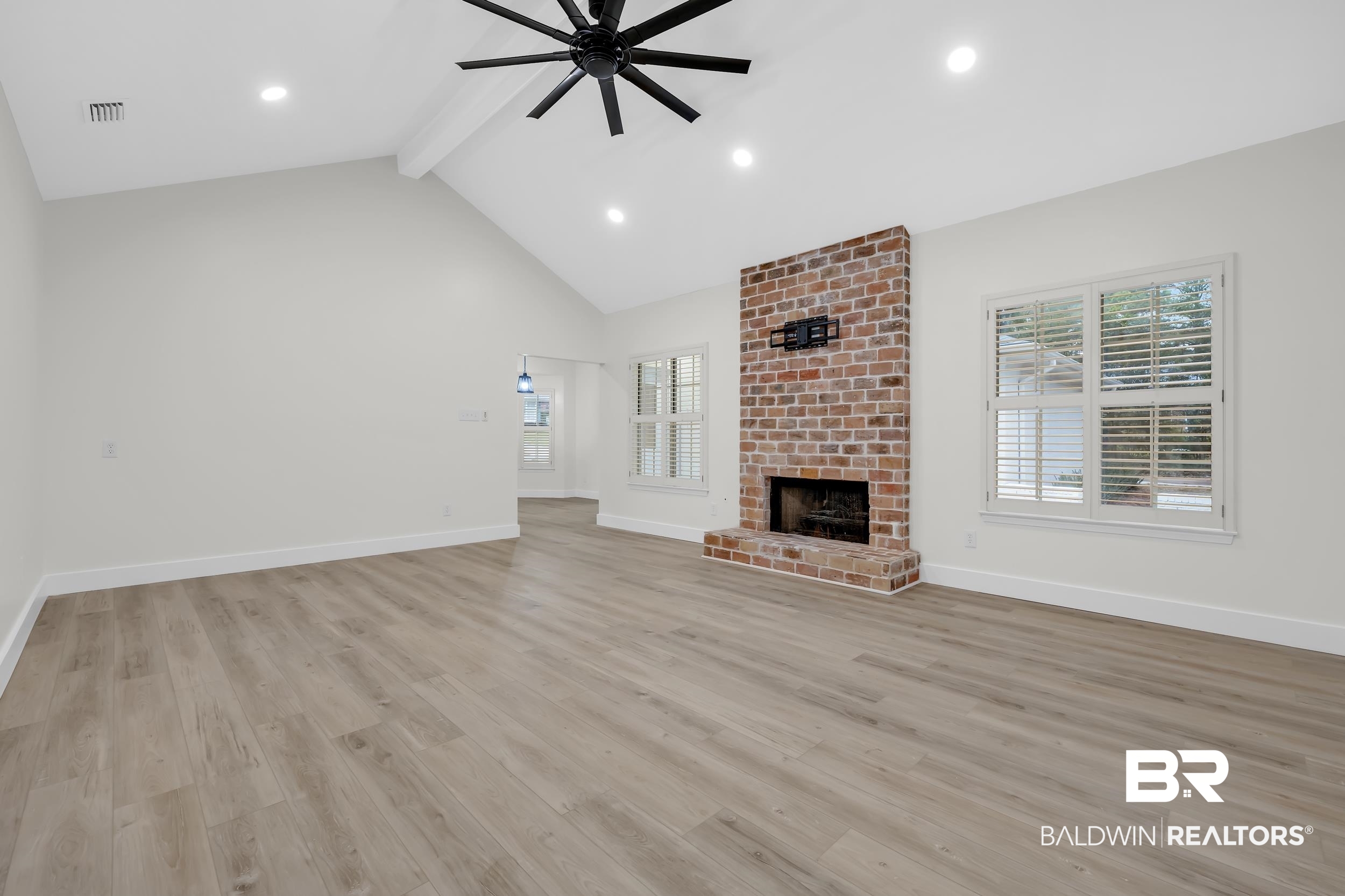 4924 Brooke Court Mobile, AL 36618 - Photo 9 of 34 Unfurnished living room with beamed ceiling, light wood-type flooring, recessed lighting, a brick fireplace, and ceiling fan